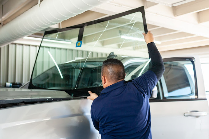 Technician fitting a new windshield